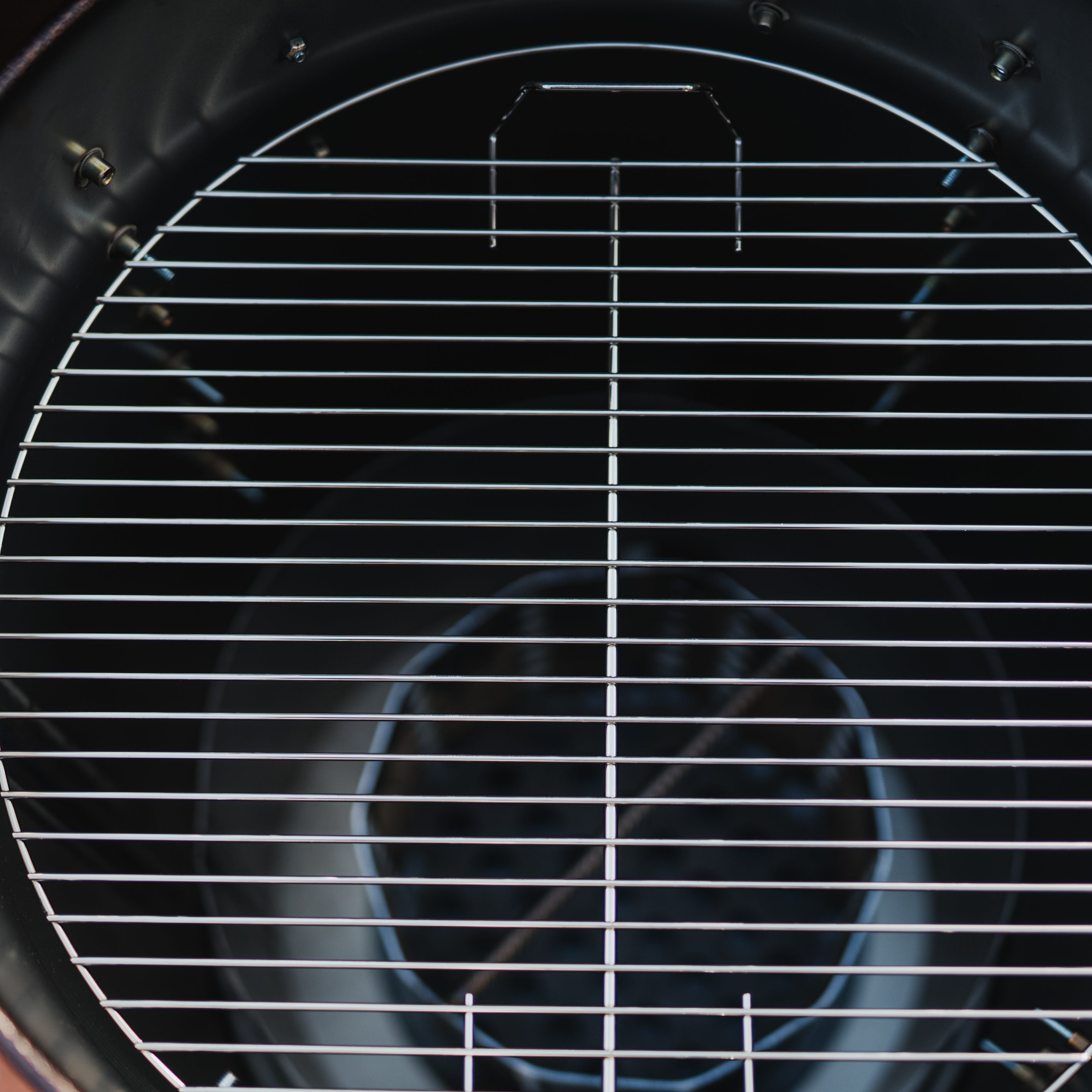 Close-up of a grill with a metal grate on a blurred background